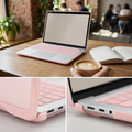 COLOUR:Pink - cased laptop on a cafe table beside a notebook