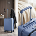 COLOUR:Blue - suitcase standing beside a hotel room door with a coat over the handle