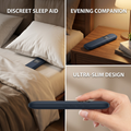 Bone conduction speaker slipped under a pillow on a made bed