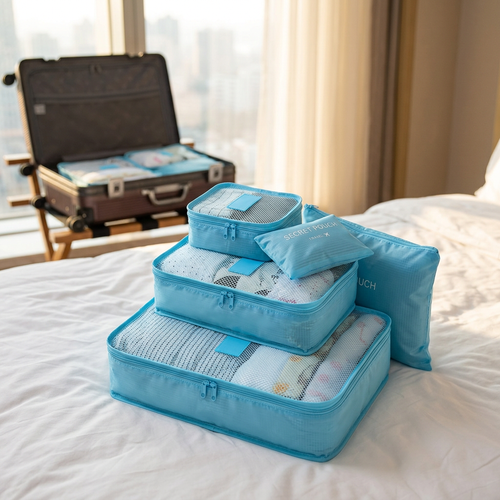 Packing cube set stacked on a hotel bed