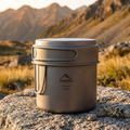 Titanium camping pot on a flat rock