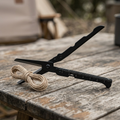 Black folding outdoor scissors on a wooden camp table