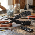 Black multifunctional pliers on a workbench with wire